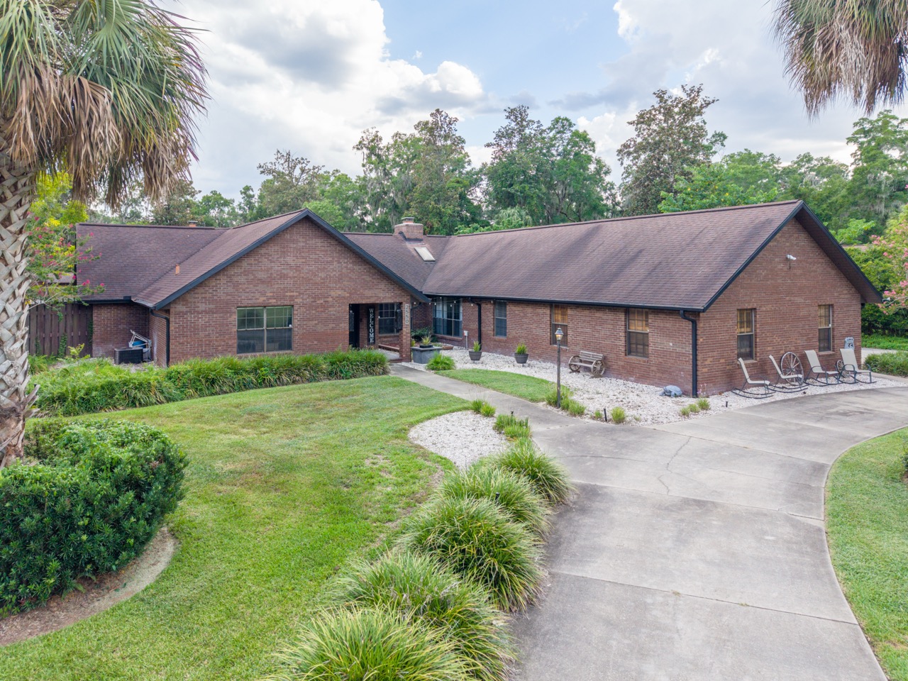 Aerial drone view of the front of the property and drive