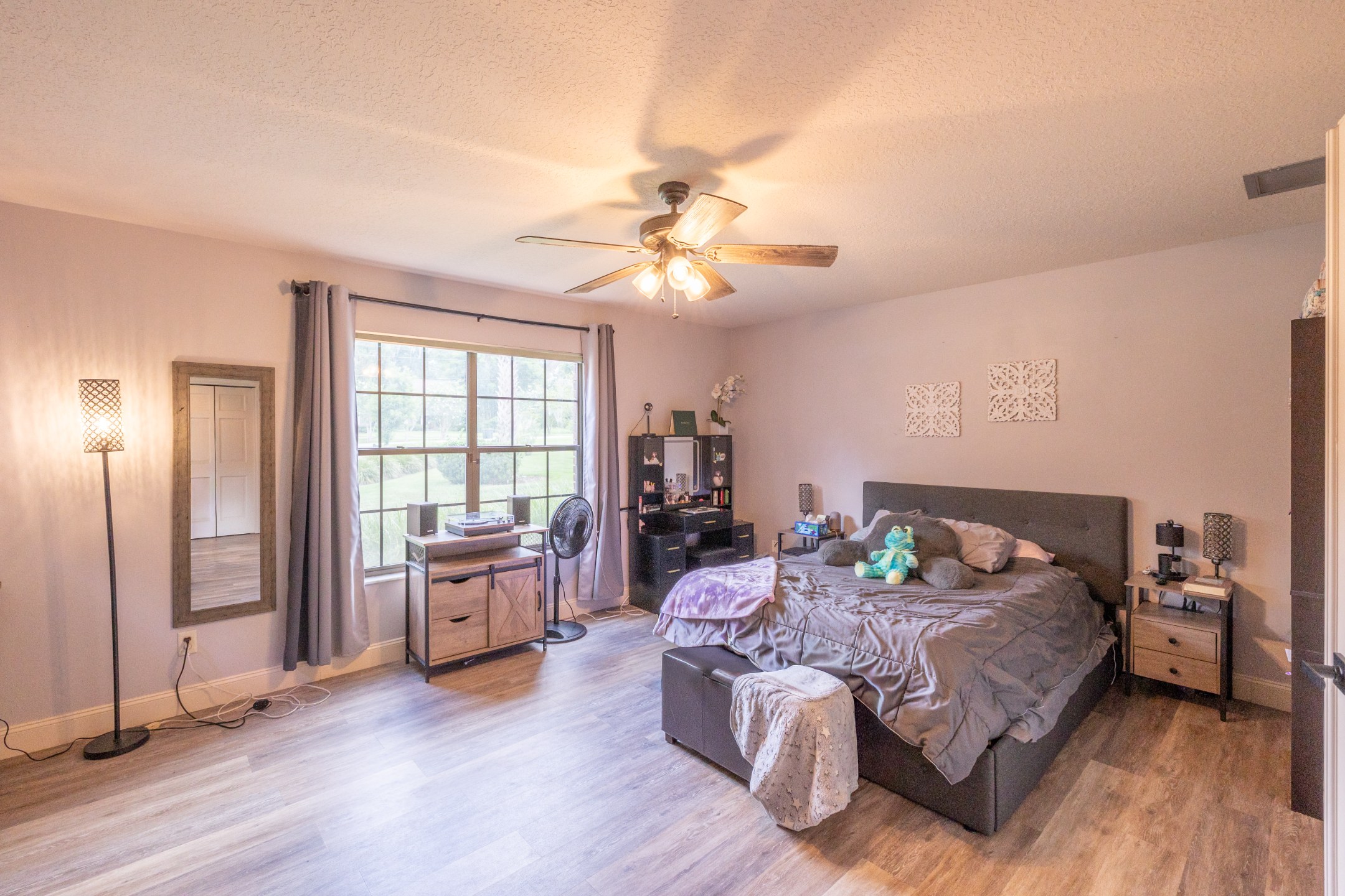 Primary suite with tray ceiling and garden views