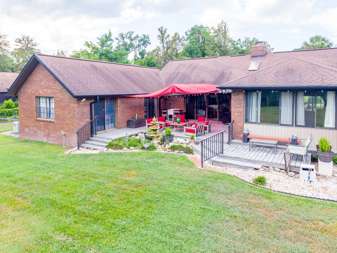 Aerial drone view of the rear of the property and wooded lot