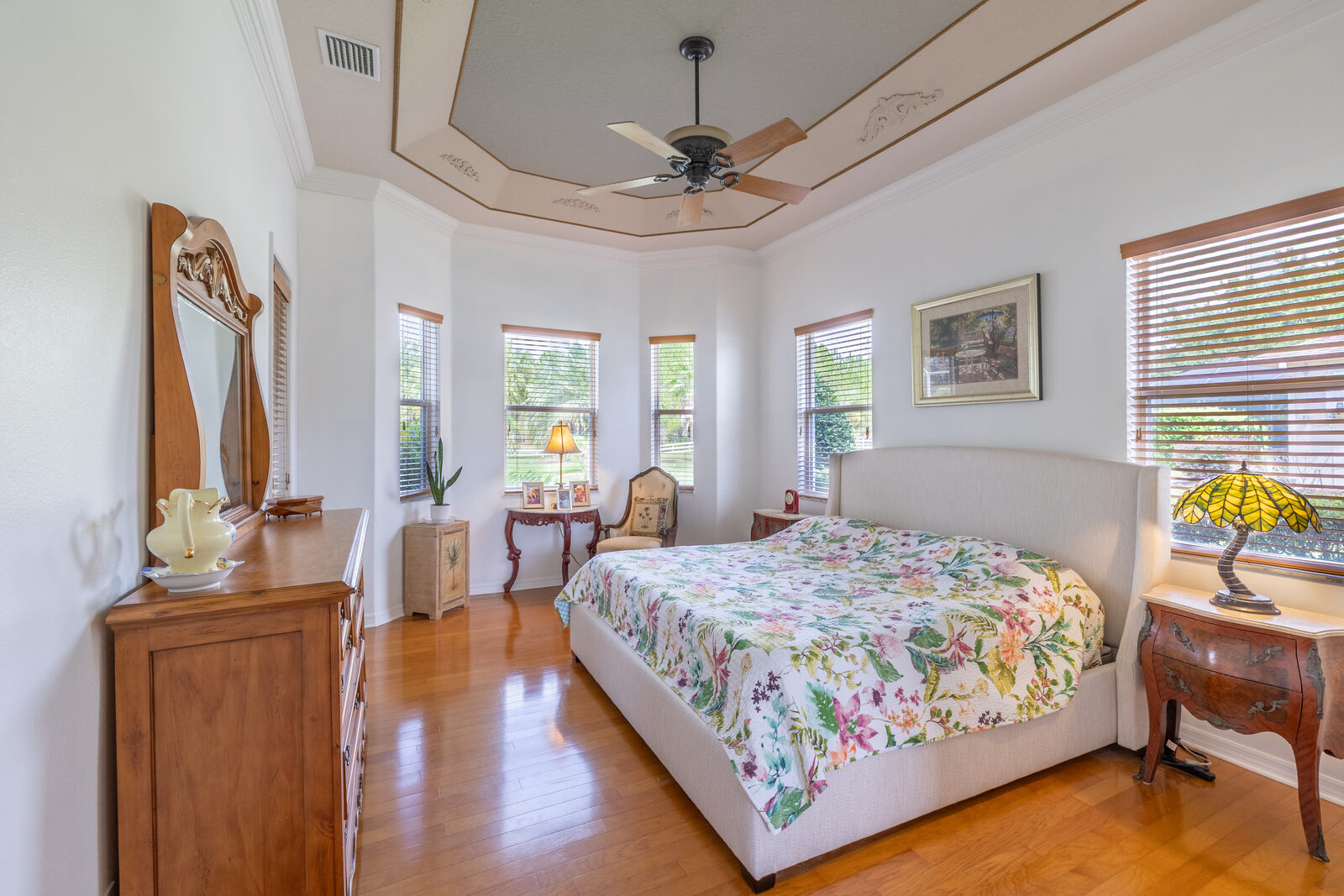 Spacious primary bedroom with tray ceiling