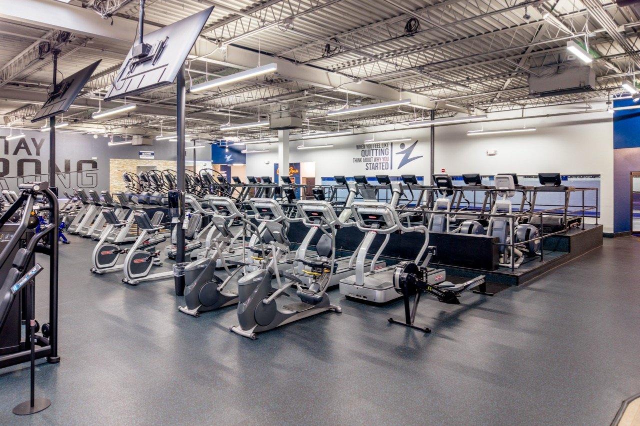 Interior of a modern gym floor with cardio equipment